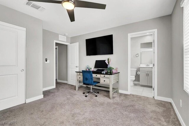carpeted office featuring visible vents, baseboards, and a ceiling fan