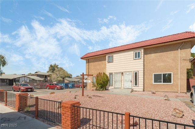 2915 Cedar Ave Unit 12C, Las Vegas, NV 89101 - exterior space with a fenced front yard, stucco siding, and a tiled roof