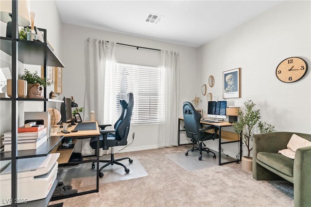 carpeted office space featuring baseboards