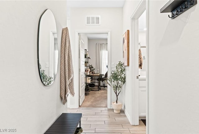 foyer entrance featuring wood finish floors and baseboards