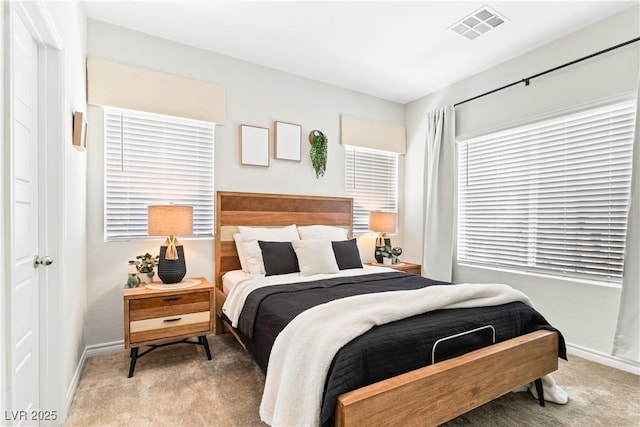carpeted bedroom with baseboards and multiple windows