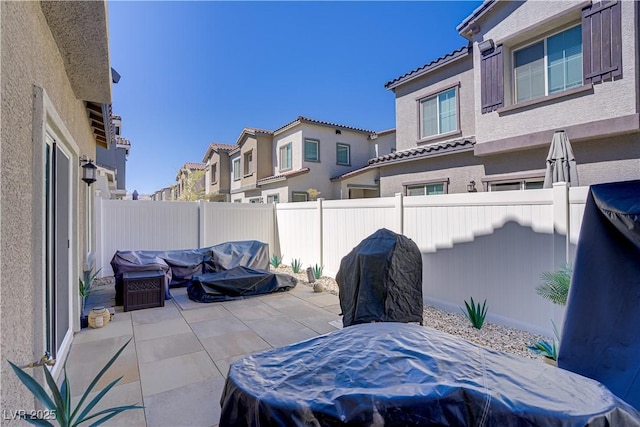 view of patio with a fenced backyard and a residential view