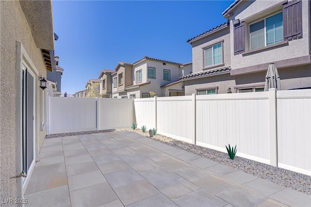 view of patio featuring a fenced backyard and a residential view