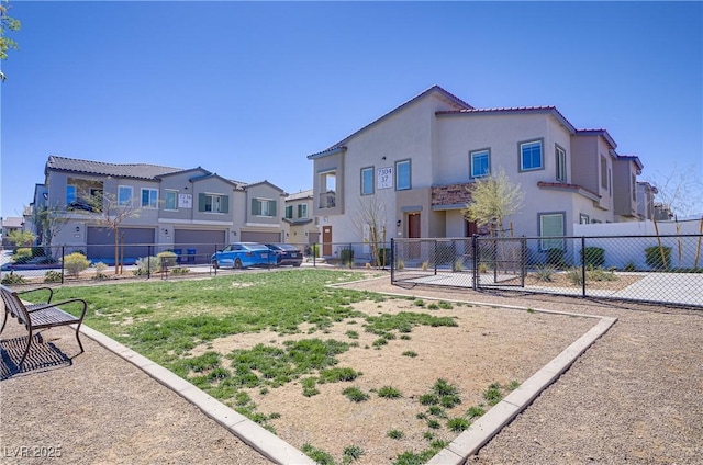 back of property with a residential view, fence, and stucco siding
