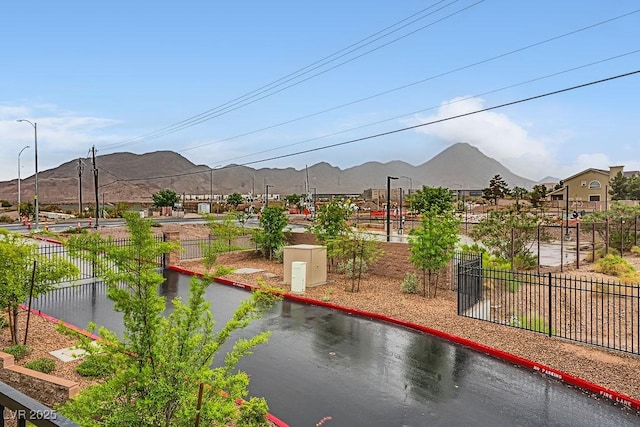 exterior space featuring a mountain view and fence