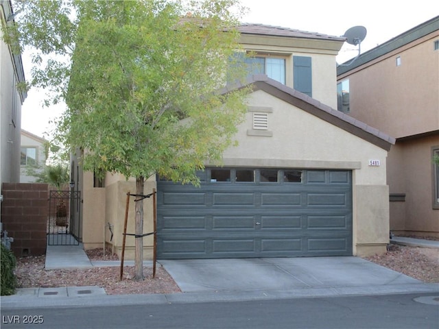 5481 Railroad River Ave, Las Vegas, NV 89139 - view of front of property featuring stucco siding, concrete driveway, a garage, and a gate
