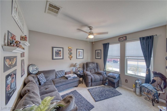 living room with visible vents, baseboards, ceiling fan, and carpet floors