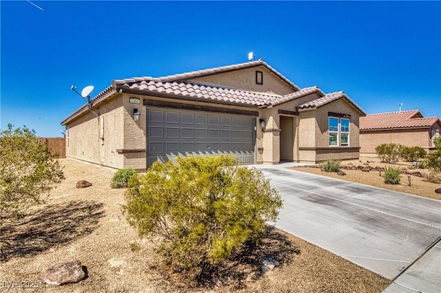 mediterranean / spanish-style house with a garage, stucco siding, driveway, and a tiled roof