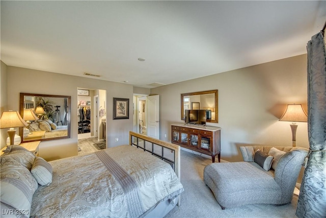 bedroom with carpet flooring, visible vents, and a spacious closet