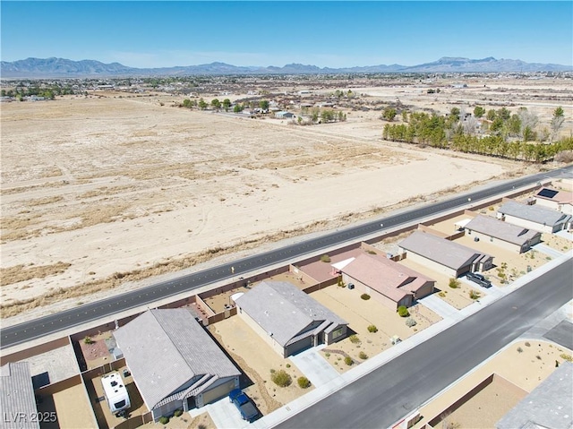 drone / aerial view with view of desert and a mountain view