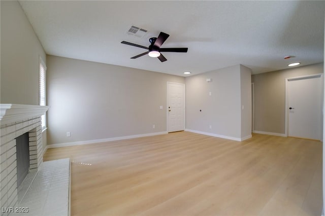 6649 W Tropicana Ave Unit 101, Las Vegas, NV 89103 - unfurnished living room with a ceiling fan, light wood-style floors, a brick fireplace, baseboards, and recessed lighting