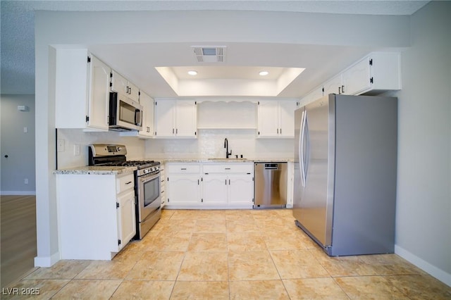 6649 W Tropicana Ave Unit 101, Las Vegas, NV 89103 - kitchen with appliances with stainless steel finishes, a sink, white cabinetry, and recessed lighting