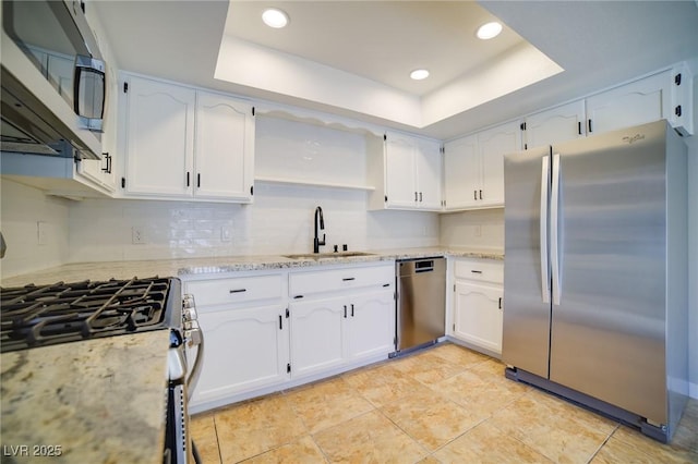 6649 W Tropicana Ave Unit 101, Las Vegas, NV 89103 - kitchen featuring appliances with stainless steel finishes, a sink, white cabinetry, a raised ceiling, and recessed lighting