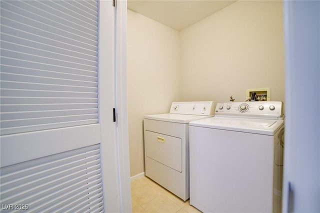 6649 W Tropicana Ave Unit 101, Las Vegas, NV 89103 - washroom with washer and dryer and light tile patterned floors