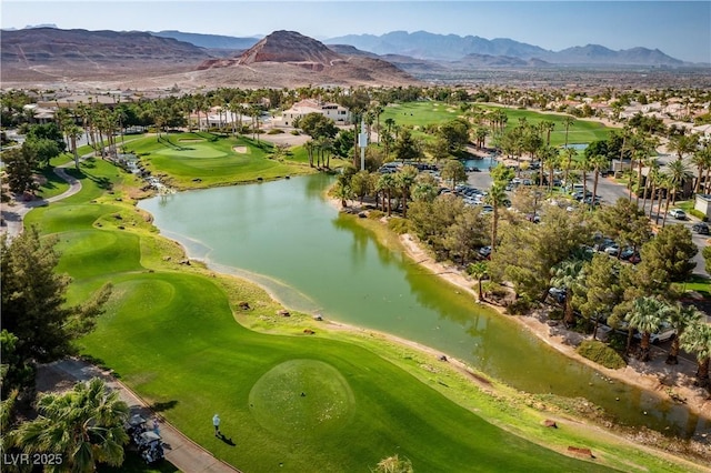 drone / aerial view featuring view of golf course, a residential view, and a water and mountain view