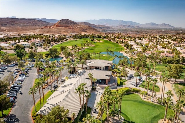 birds eye view of property featuring a water and mountain view, view of golf course, and a residential view