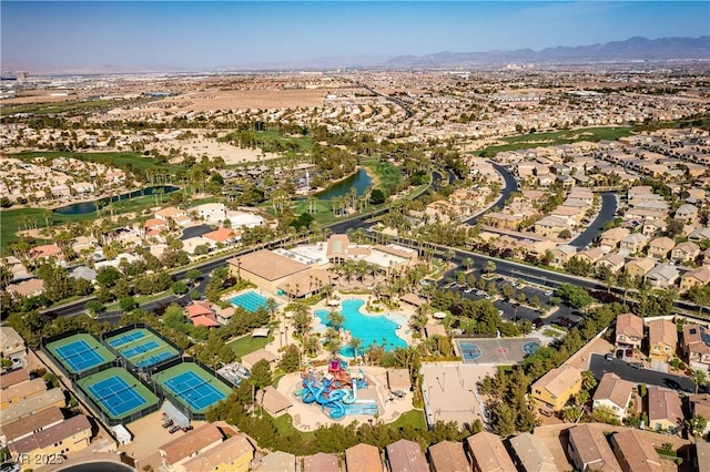 drone / aerial view with a water and mountain view and a residential view