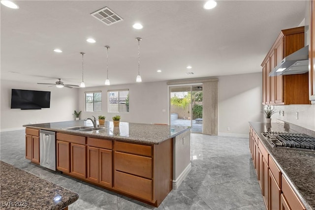 kitchen featuring visible vents, open floor plan, under cabinet range hood, a sink, and appliances with stainless steel finishes