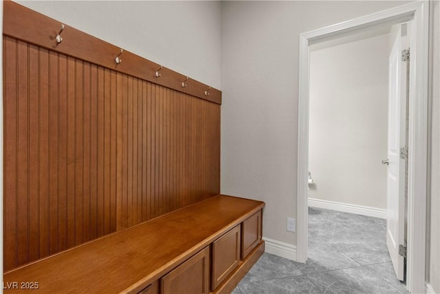 mudroom featuring baseboards and light tile patterned floors