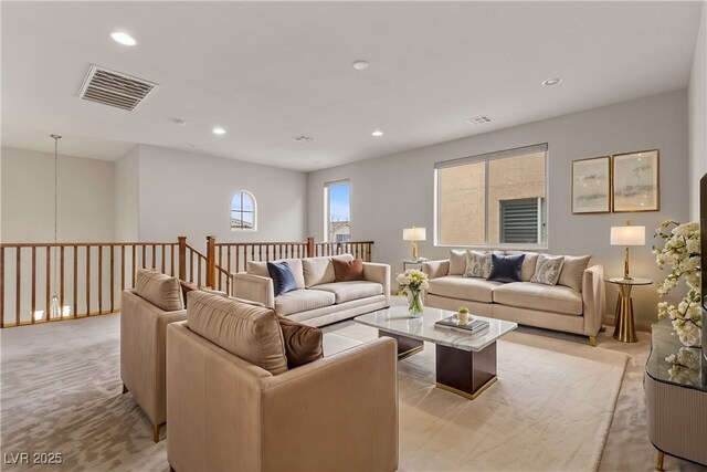 living room featuring recessed lighting, visible vents, and light carpet
