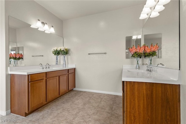 full bath featuring vanity, baseboards, and tile patterned floors