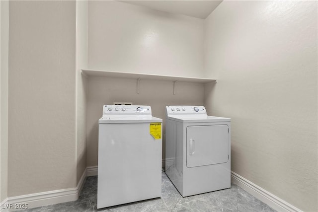 laundry room with separate washer and dryer, laundry area, and baseboards