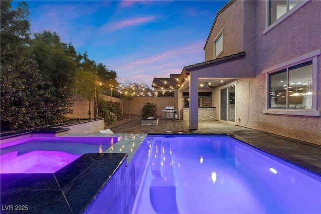 view of pool with an in ground hot tub, a fenced in pool, a fenced backyard, and a patio area