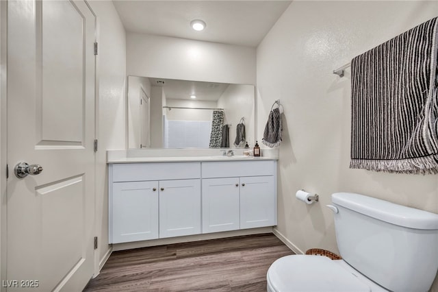 3725 Celesta Vista Ave, Henderson, NV 89044 - full bathroom with wood finished floors, toilet, baseboards, a shower with shower curtain, and vanity