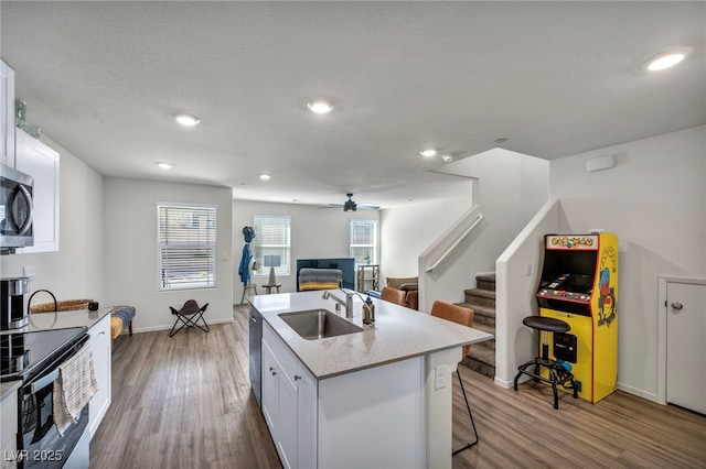 3725 Celesta Vista Ave, Henderson, NV 89044 - kitchen with a sink, stainless steel appliances, wood finished floors, ceiling fan, and recessed lighting