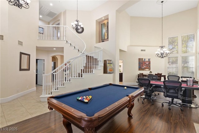 9517 Spanish Steps Ln, Las Vegas, NV 89117 - playroom with a high ceiling, a chandelier, baseboards, wood finished floors, and arched walkways