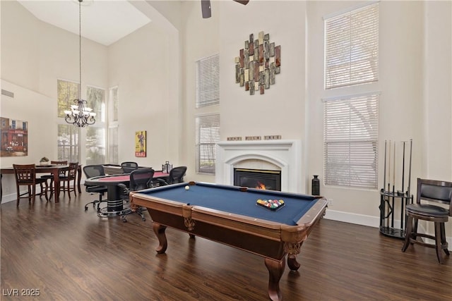 9517 Spanish Steps Ln, Las Vegas, NV 89117 - playroom with a towering ceiling, pool table, baseboards, dark wood finished floors, and a warm lit fireplace