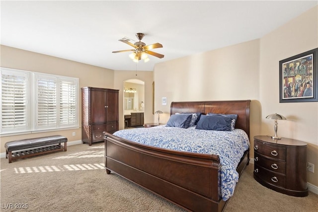 9517 Spanish Steps Ln, Las Vegas, NV 89117 - bedroom featuring light carpet, arched walkways, baseboards, and a ceiling fan