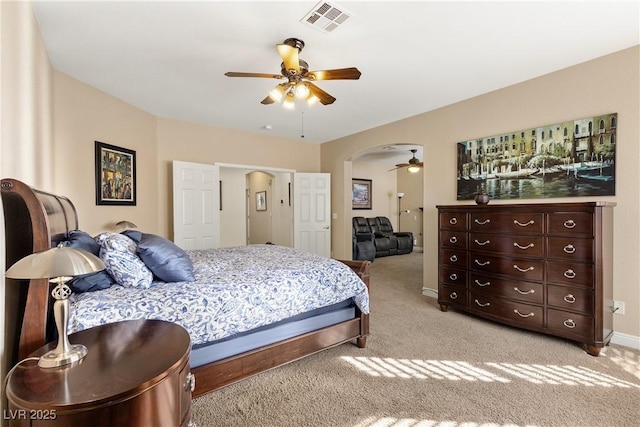9517 Spanish Steps Ln, Las Vegas, NV 89117 - bedroom featuring light carpet, arched walkways, and a ceiling fan