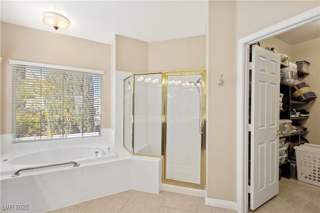 9517 Spanish Steps Ln, Las Vegas, NV 89117 - bathroom featuring a shower stall, tile patterned floors, plenty of natural light, and a spacious closet