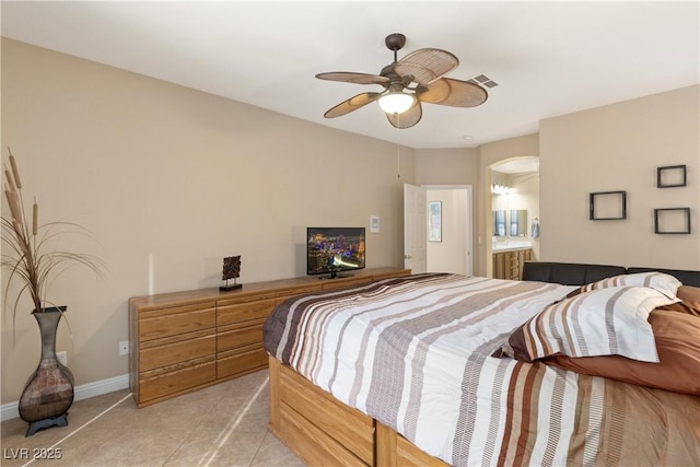 9517 Spanish Steps Ln, Las Vegas, NV 89117 - bedroom featuring light tile patterned floors, baseboards, arched walkways, ensuite bathroom, and a ceiling fan