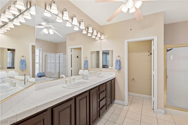 9517 Spanish Steps Ln, Las Vegas, NV 89117 - bathroom featuring ceiling fan, a stall shower, tile patterned floors, double vanity, and baseboards