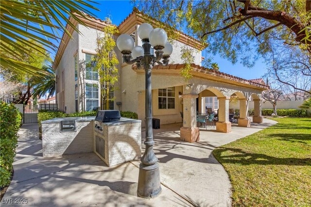 9517 Spanish Steps Ln, Las Vegas, NV 89117 - rear view of property with area for grilling, stucco siding, a patio area, and a tiled roof