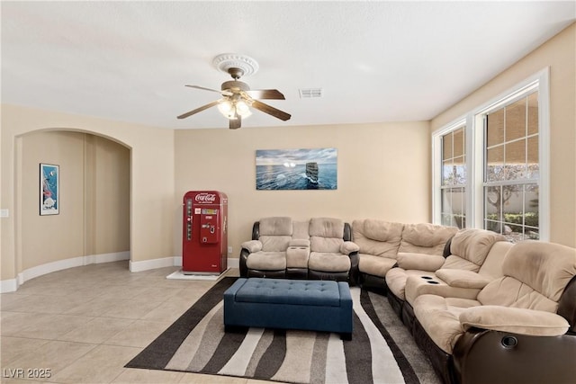 9517 Spanish Steps Ln, Las Vegas, NV 89117 - living room with light tile patterned flooring, ceiling fan, baseboards, and arched walkways
