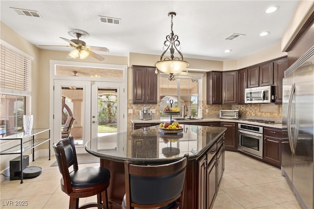 9517 Spanish Steps Ln, Las Vegas, NV 89117 - kitchen featuring appliances with stainless steel finishes, a sink, backsplash, light tile patterned floors, and recessed lighting