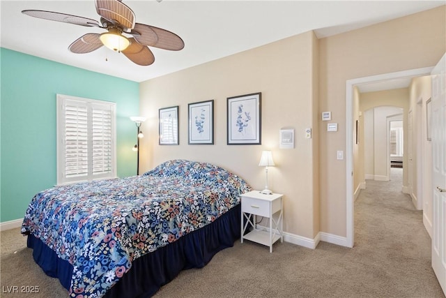 9517 Spanish Steps Ln, Las Vegas, NV 89117 - bedroom featuring carpet, baseboards, arched walkways, and a ceiling fan