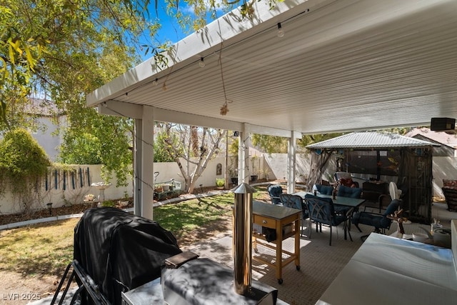 8125 Boxberry Ave, Las Vegas, NV 89131 - view of patio featuring a gazebo, outdoor dining space, a fenced backyard, area for grilling, and an outdoor hangout area