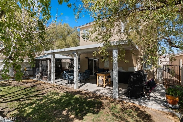 8125 Boxberry Ave, Las Vegas, NV 89131 - rear view of house featuring a gazebo, stucco siding, fence, and a patio area