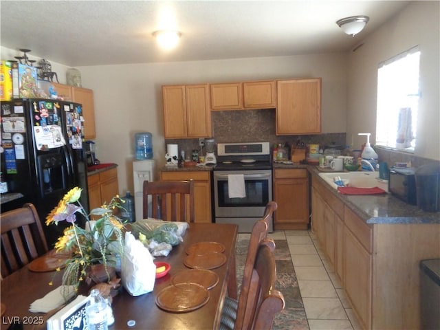 3127 Aloha Ave, Las Vegas, NV 89121 - kitchen with tasteful backsplash, light tile patterned floors, stainless steel range with electric cooktop, black fridge with ice dispenser, and a sink
