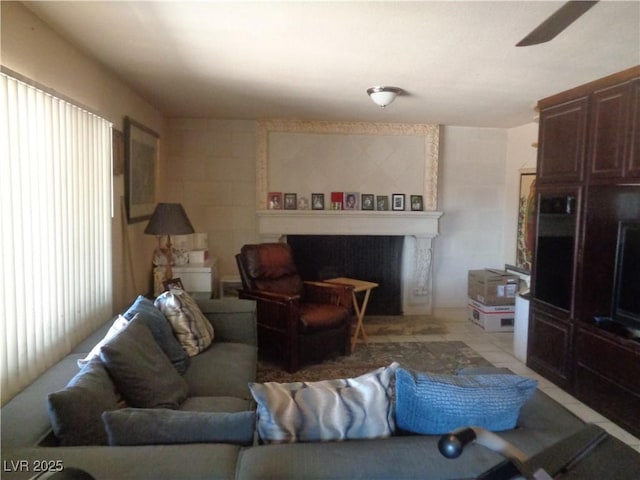 3127 Aloha Ave, Las Vegas, NV 89121 - living area featuring light tile patterned floors, ceiling fan, and a fireplace