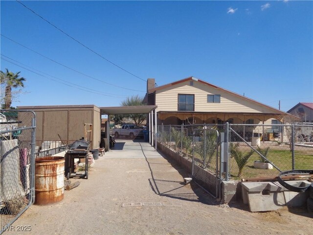 3127 Aloha Ave, Las Vegas, NV 89121 - exterior space featuring an attached carport, driveway, and fence