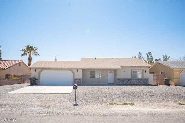 ranch-style house featuring concrete driveway, fence, a garage, and stucco siding