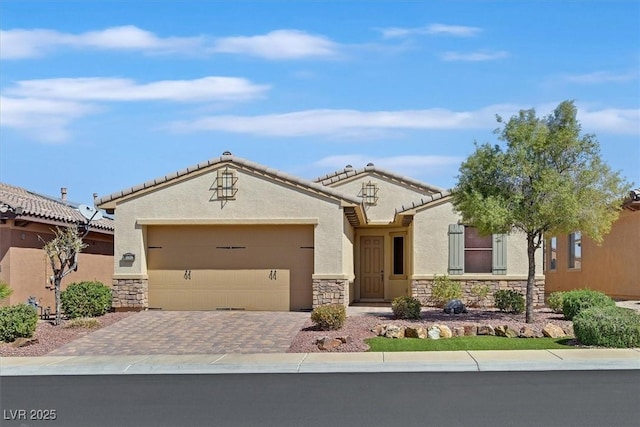 ranch-style house with stone siding, stucco siding, decorative driveway, and a garage