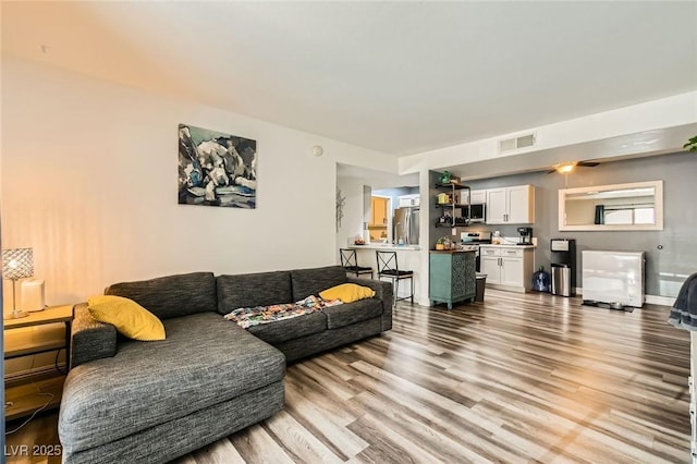 950 Seven Hills Dr Unit 814, Henderson, NV 89052 - living room featuring baseboards, visible vents, and light wood-style floors