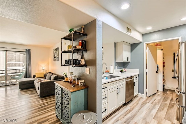 950 Seven Hills Dr Unit 814, Henderson, NV 89052 - kitchen with visible vents, light wood-style flooring, stainless steel appliances, a sink, and open shelves