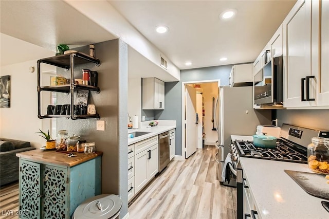 950 Seven Hills Dr Unit 814, Henderson, NV 89052 - kitchen featuring visible vents, light wood finished floors, recessed lighting, appliances with stainless steel finishes, and open shelves